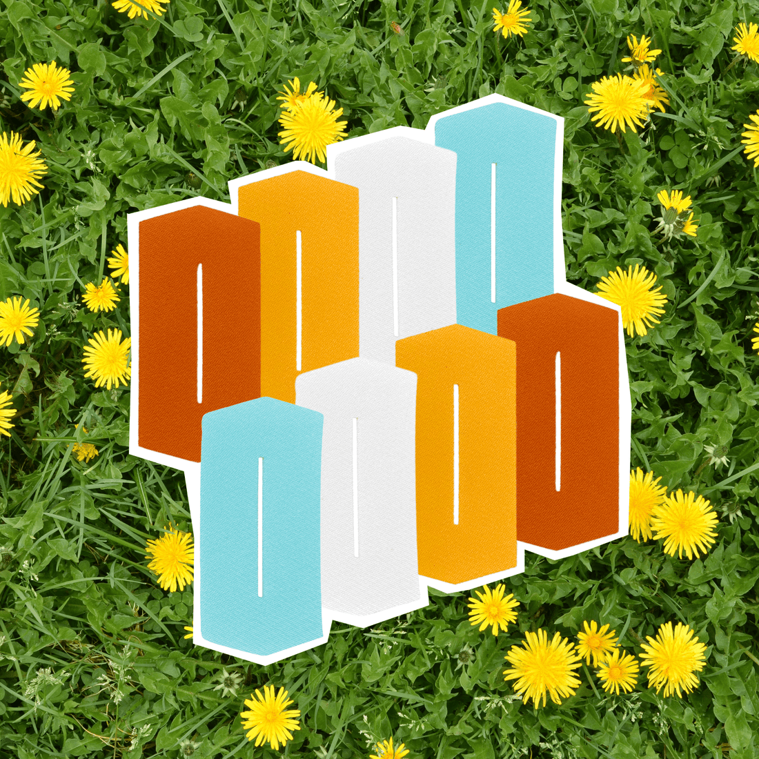 colorful-tube-eeze-patches-on-a-green-grass-field-filled-with-yellow-dandelions,-showcasing-unique-iron-on-designs.