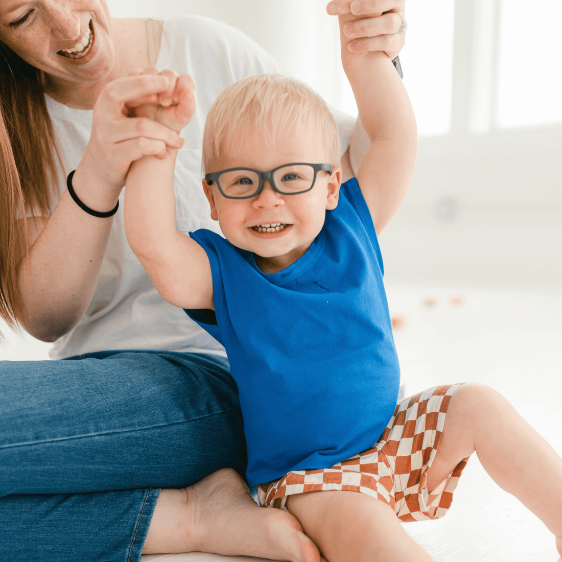 happy-toddler-in-snappy-tee,-smiling-and-playing-with-parent,-showcasing-convenient-shoulder-snaps-for-easy-dressing.