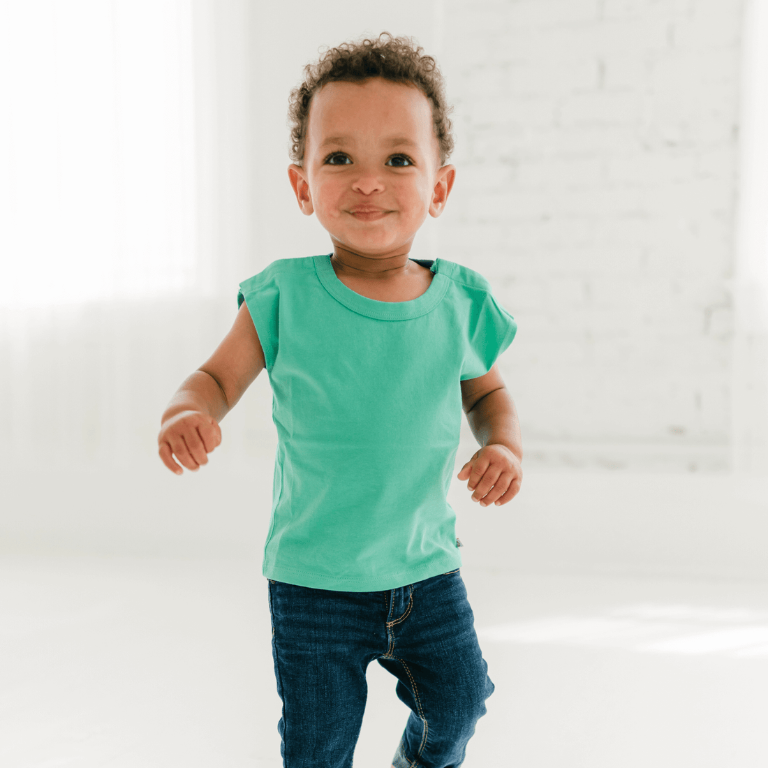 baby-wearing-a-green-snappy-tee,-perfect-for-easy-dressing-and-comfortable-play.